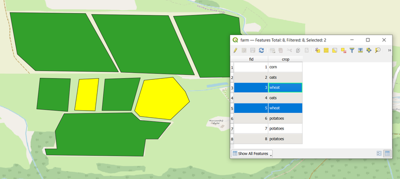 Wheat fields highlighted in the attribute table and in the map canvas.